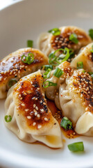 Wall Mural - Korean style pan fried vegan dumplings with red chilli oil sauce served on a white plate for a delicious meal experience. Asian dumplings, dish, recipe. Jiaoji, Gyoza