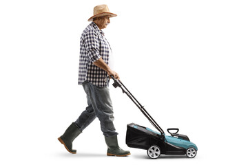 Poster - Full length profile shot of a gardener using a lawnmower