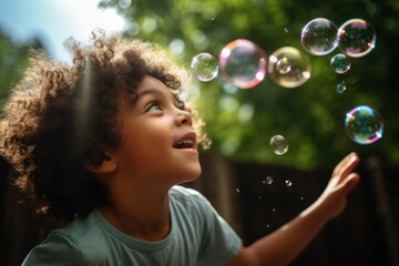 Canvas Print - Latin cuban boy blowing bubbles while playing in playground portrait summer child.