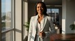 © TJ_Designs - beautiful smile woman wearing a business suit, standing in the office, sunshine, with a little bit of blurred background with copy space