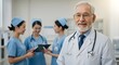 © TJ_Designs - A happy doctor in medical uniform, in a hospital with other nurses, with a little bit of blurred background with side copy space, with background sunshine