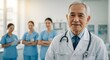 © TJ_Designs - A happy doctor in medical uniform, in a hospital with other nurses, with a little bit of blurred background with side copy space, with background sunshine