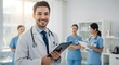 © TJ_Designs - A happy doctor in medical uniform, in a hospital with other nurses, with a little bit of blurred background with side copy space, with background sunshine