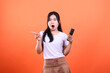 © Ajab - Surprised woman in white shirt pointing with one hand while holding phone on another hand