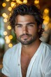© Tatiana - Handsome young man with dark hair and warm smile posing against dreamy bokeh background in a cozy atmosphere