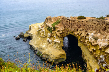 Wall Mural - 2024-06-28 ROCKY SHORELINE AND CAVE WITH A NICE REFLECTION AND SKY IN THE DISTANCE AT THE LA JOLLA COVE NEAR SAN DIEGO CALIFORNIA