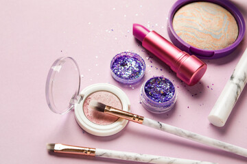 Wall Mural - Composition with jar of glitter, makeup products and brushes on lilac background, closeup