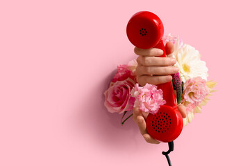 Canvas Print - Female hand with retro telephone and flowers visible through hole in pink teared paper