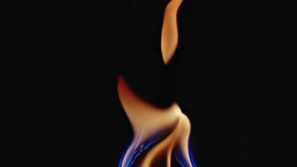 Poster - Flame with blue and orange hues on black background, abstract art. Energy and transformation concept