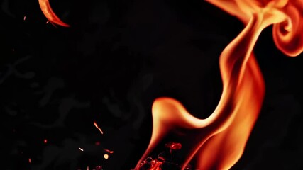 Poster - Close-up of a swirling flame against a black background, bright orange and red hues. Fire, heat, and energy concept