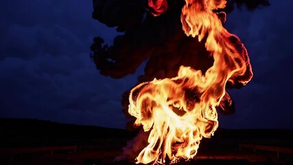 Poster - Mesmerizing fire swirling against dark night sky, illuminating surroundings with intense orange and yellow hues. Energy and passion concept