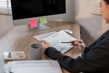 Wall Mural - Business financing accounting banking concept. Business asian woman hand doing finances and calculate on desk about cost at office. Woman working on desk with using calculator, finance accounting.
