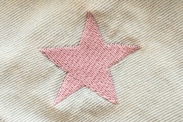 pink star patch on jeans texture background