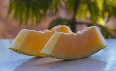 Wall Mural - Two slices of very juicy melon on the table.