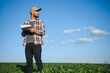 © Serhii - Farmer in soybean fields. Growth outdoor