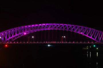 Wall Mural - illuminated bridge on the sea in the night