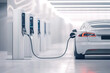 © Heart in pictures - Electric vehicle charging station with sleek car in modern indoor setting
