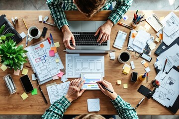 Poster - Creative web designers developing a UI/UX concept at a cluttered desk.
