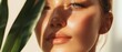 © Gpeg26 - Close-up of a young woman’s glowing face with natural sunlight and leaf shadows casting over her skin, capturing beauty and freshness.