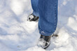 © Виталина Митрофанова - winter-themed close-up person standing in the snow blue jeans black shoes snow sticking to the shoes winter fashion footwear activities walking outdoor adventures resilience travel cold seasonal legs