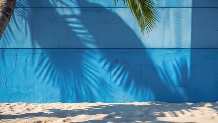 Poster - tropical palm shadows on bright blue cement wall with sandy beach background ideal for organic and c