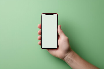 Poster - Smartphone in Hand Mockup on Green Background. Mobile phone held in hand demonstrating app interface on smart device with blank screen for mockup. Hand holding smartphone with empty display