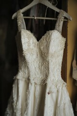 Poster - A wedding dress hung up on a hanger, ready for use or display