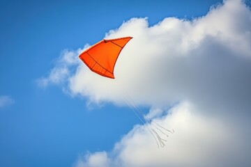 Poster - A red kite flying against a backdrop of blue clouds