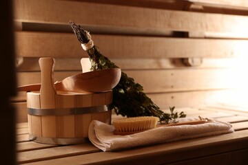 Wall Mural - Massaging brush, towel, bucket, whisk and ladle on wooden bench in sauna