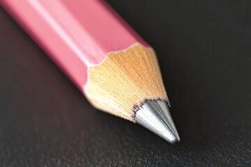 Aufkleber - A close-up shot of a pink pencil resting on a black surface