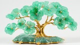 A handcrafted lucky tree with jade leaves and a gold base, beautifully arranged on a white background.