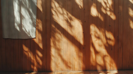 Poster - Warm hardwood wall with fabric panel and sunlit shadows - interior design inspiration