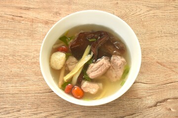 Wall Mural - boiled day lily topping tofu with pork bone and ear mushroom in Chinese herb soup on bowl 