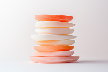 Leinwandbilder - Smooth pill-shaped forms stacked in gentle tiers, transitioning from warm pink at the base to a