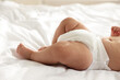 © New Africa - Cute little baby in diaper on bed, closeup