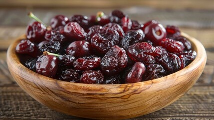 Poster - A wooden bowl filled with fresh cherries and dried cherries, showcasing their vibrant colors.