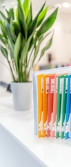 Leinwandbilder - Minimalist Healthcare Office Colorful Document File System with Labels on White Desk for Streamlined Medical Administration and Modern Office Aesthetics