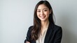 © uu - smiling young Asian businesswoman in a black blazer. Confident and successful