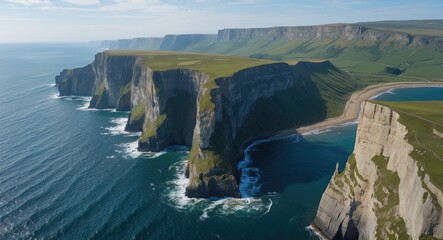 Wall Mural - Aerial view of dramatic cliffs along the coastline with green grasslands meeting the ocean under a clear blue sky