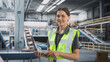© Gorodenkoff - Modern Sorting Center: Female Stocking Associate Uses Laptop, Looking At Camera And Smiling. Transportation Logistics Warehouse Facility with Conveyor Loading Product Boxes To Deliver To Customers.