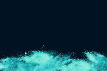 Wall Mural - abstract powder splatted background. green powder explosion on black background copy space. colored 