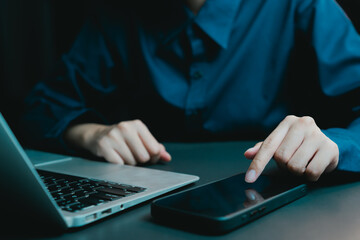 Poster - Woman in Blue Shirt Using Smartphone Next to Laptop on Table