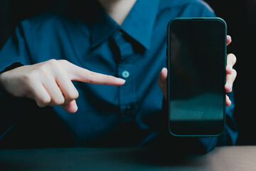 Poster - Person Pointing to Empty Smartphone Screen in Dark Room