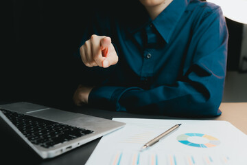 Poster - Business professional pointing at document with laptop and charts