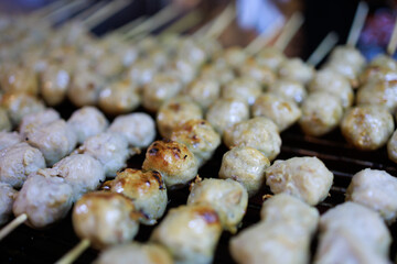 Wall Mural - Top view of Pork meatballs grill on a charcoal stove, focus selective