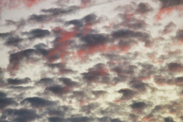 Wall Mural - a beautiful sky tinted by the sun leaving vibrant shades of gold, pink, blue and multicolored. cloud