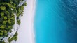 © Diffin - Aerial perspective showcasing a pristine beach featuring soft white sand and vibrant blue water, highlighting the beauty of natural coastal landscapes.