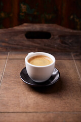 Wall Mural - Cup of coffee on wooden background. Soft focus. Copy space.