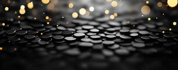 Poster - Black circular stones with blurred golden bokeh background create serene and elegant atmosphere. smooth texture and soft lighting enhance visual appeal