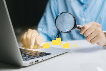 Poster - Person Using Magnifying Glass to Examine Digital Data on Laptop